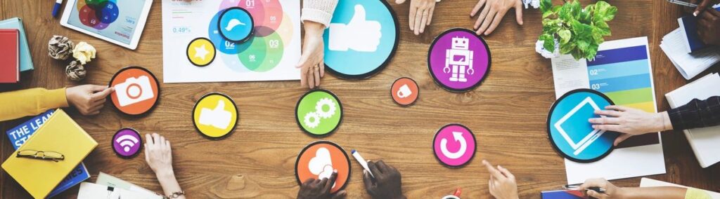 People gathered around social media symbols atop a table