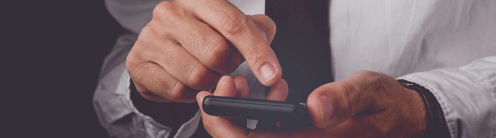 a man reading a cold email on his phone